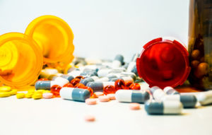 Prescription drug bottles with pills spilling out