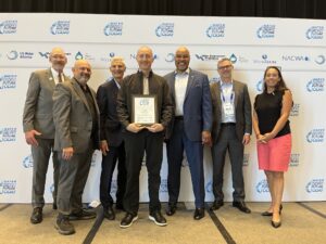 James McClendon, Finance & Administrative Manager for the City of Eugene's Wastewater Division, accepted the award on behalf of the MWMC at the 2025 WEF Tech Conference in Chicago. James, pictured above holding the framed award, received it from the WEF Awards Committee.